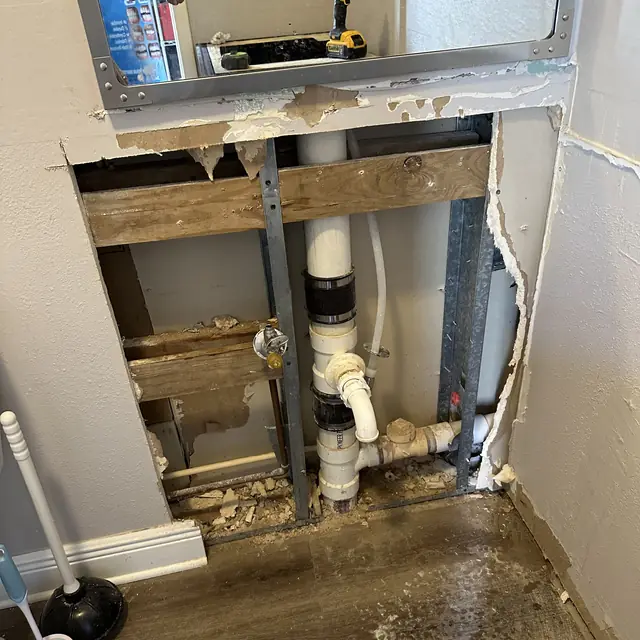 Drain and vent rough-in framed into an opened interior wall