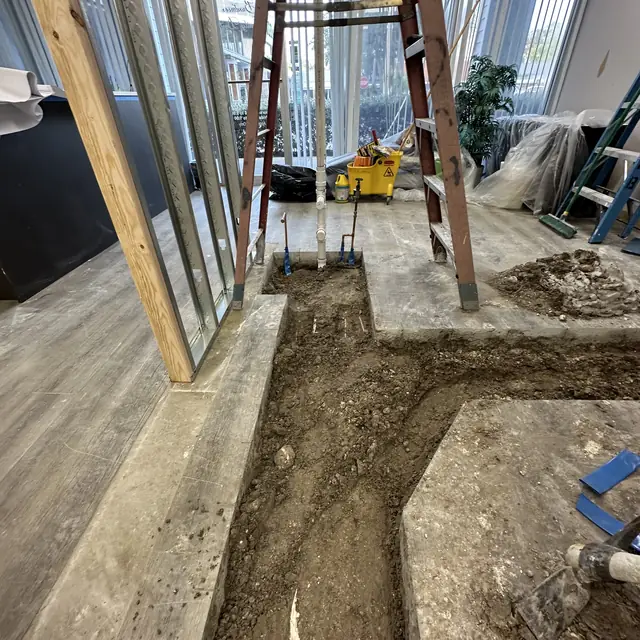 Trench cut across a commercial floor for new drain lines