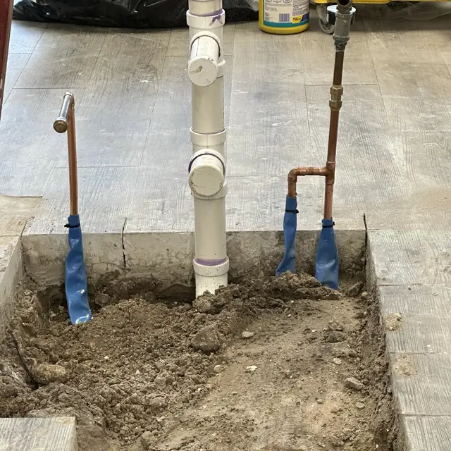 PVC stack and copper supply risers set in a trenched slab